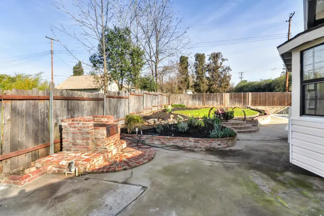 a view of a swimming pool with a patio and a yard
