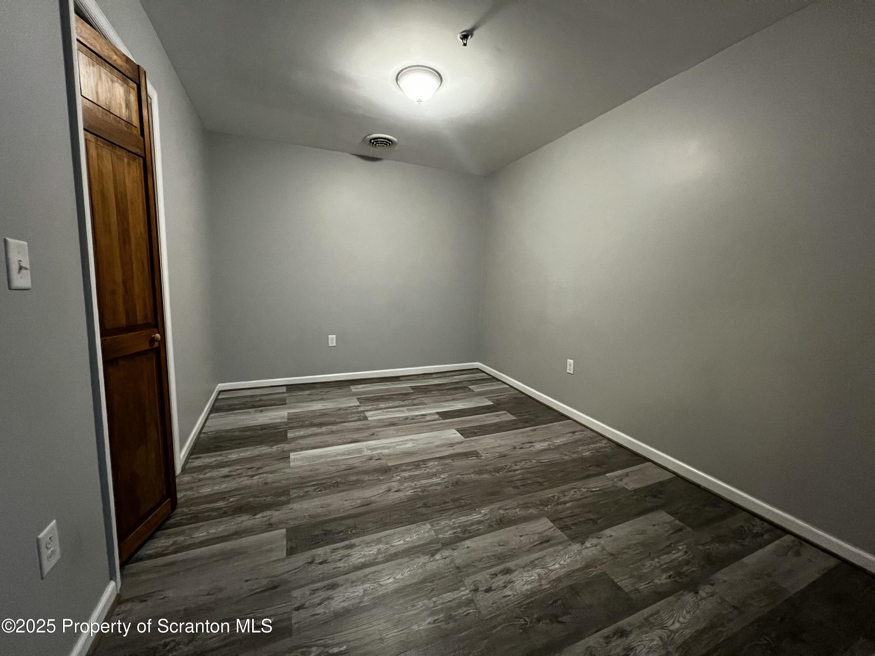 205 North Washington Avenue, Unit 2 Scranton, PA 18503 - Photo 12 of 12 a view of room with window and wooden floor