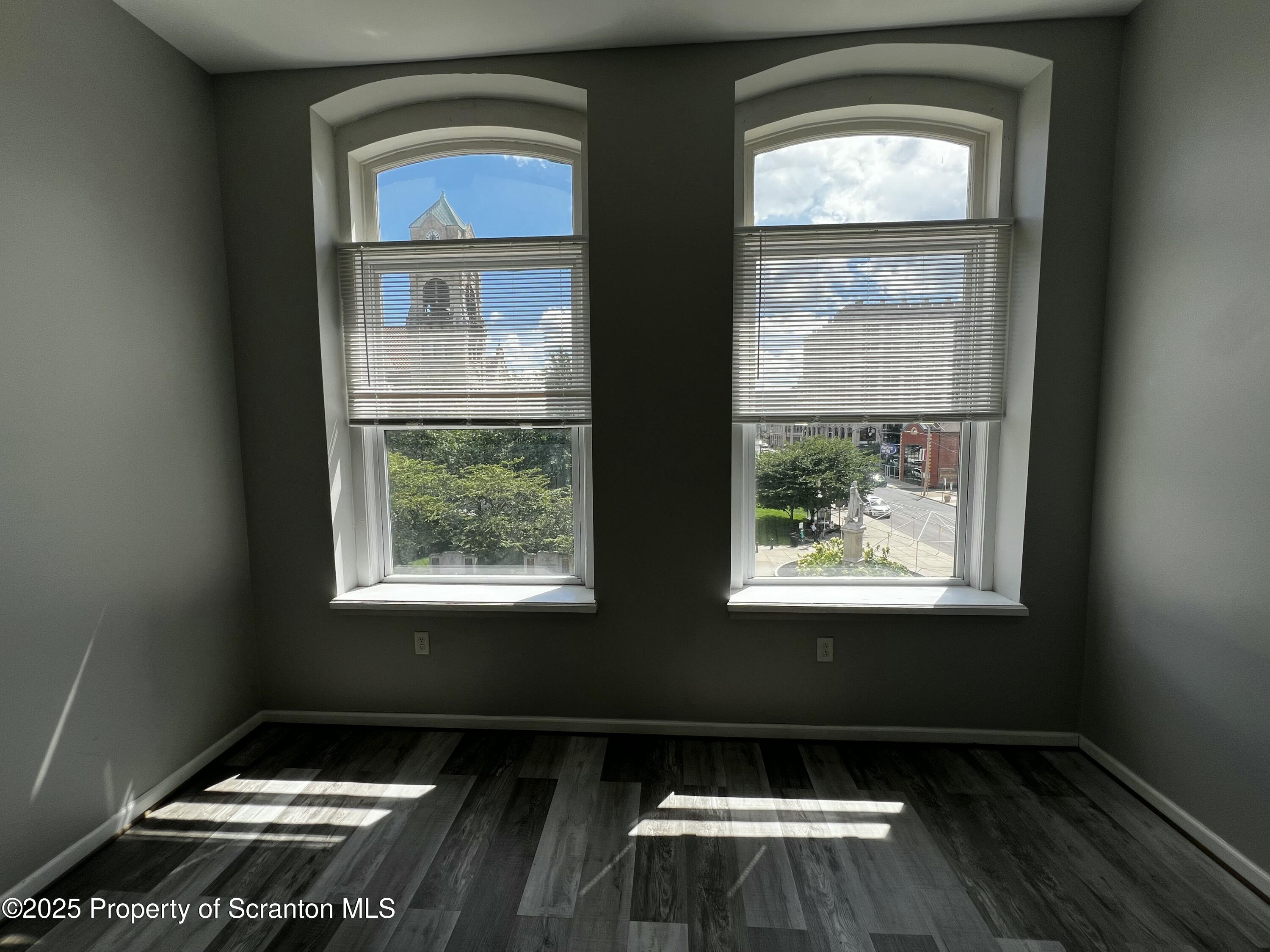 205 North Washington Avenue, Unit 2 Scranton, PA 18503 - Photo 6 of 12 an empty room with wooden floor and a window