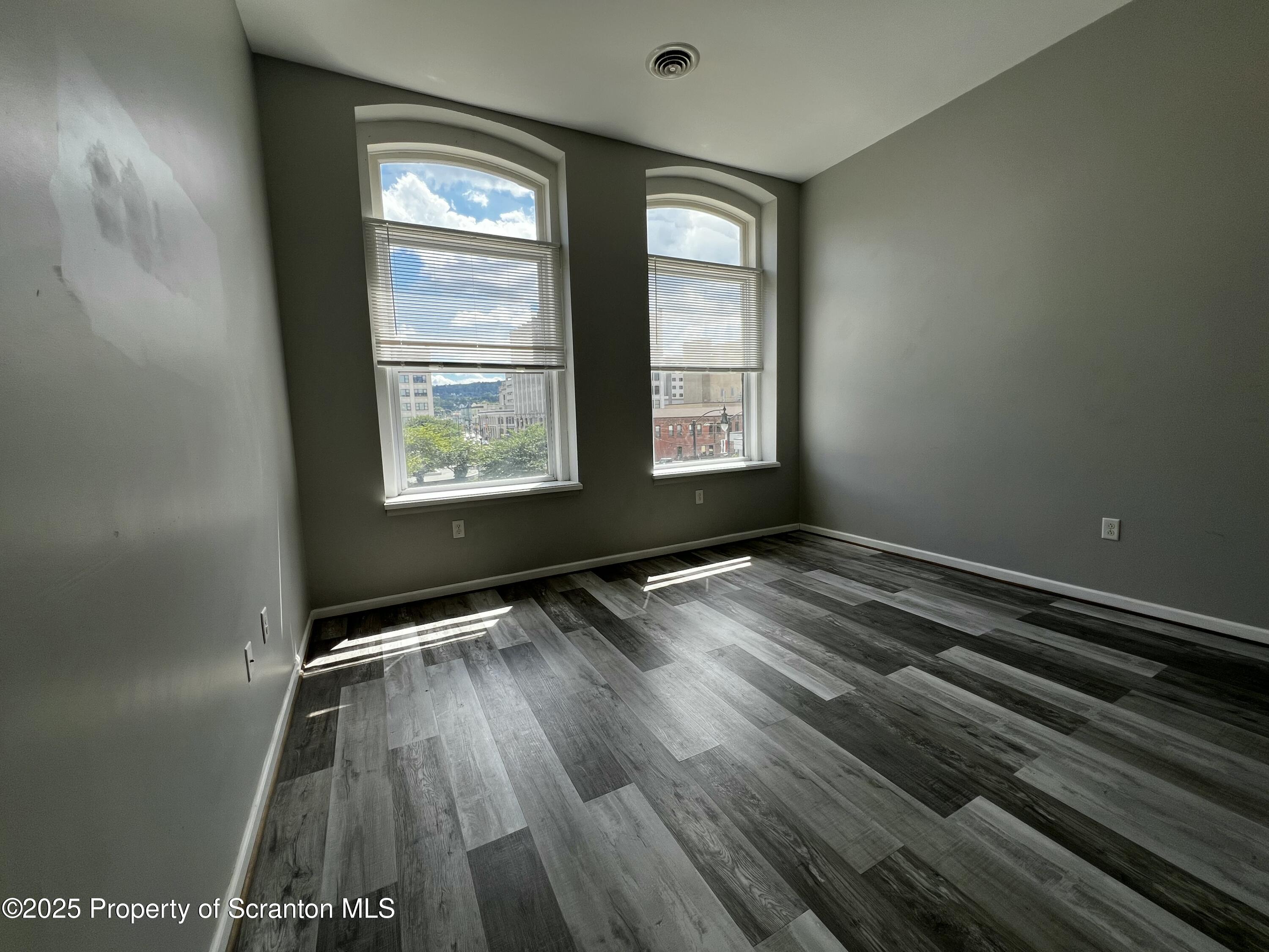 205 North Washington Avenue, Unit 2 Scranton, PA 18503 - Photo 9 of 12 a view of an empty room with wooden floor and a window