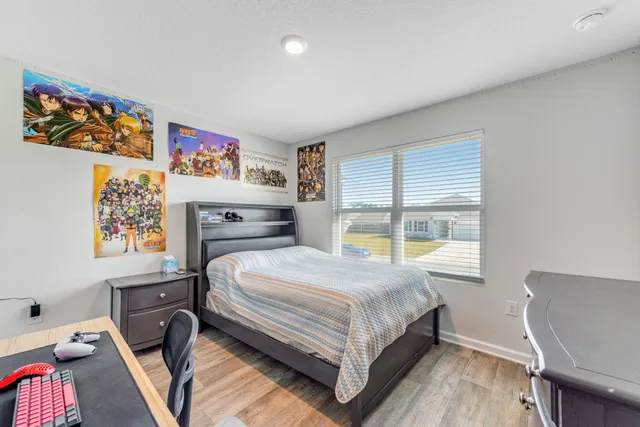 a bedroom with a bed and a desk