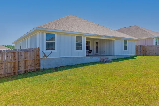a view of an house with backyard and swimming pool