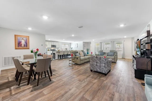 a living room with furniture and a wooden floor