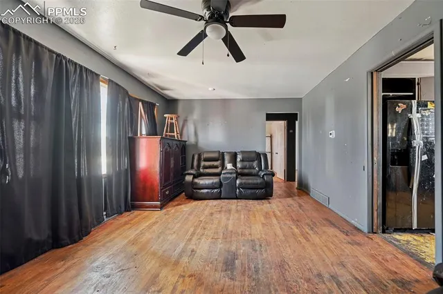 a spacious bedroom with a bed and a chandelier