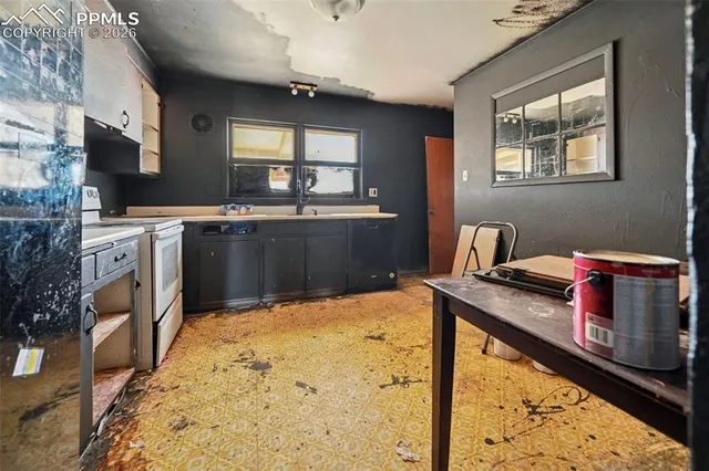 a kitchen with stainless steel appliances kitchen island granite countertop a stove a sink and a microwave