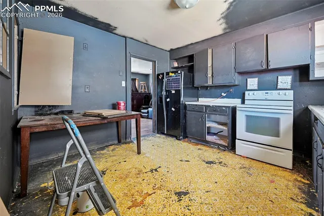 a kitchen with kitchen island granite countertop a stove and a sink