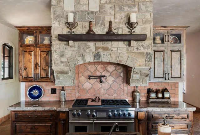 a stove top oven sitting inside of a kitchen