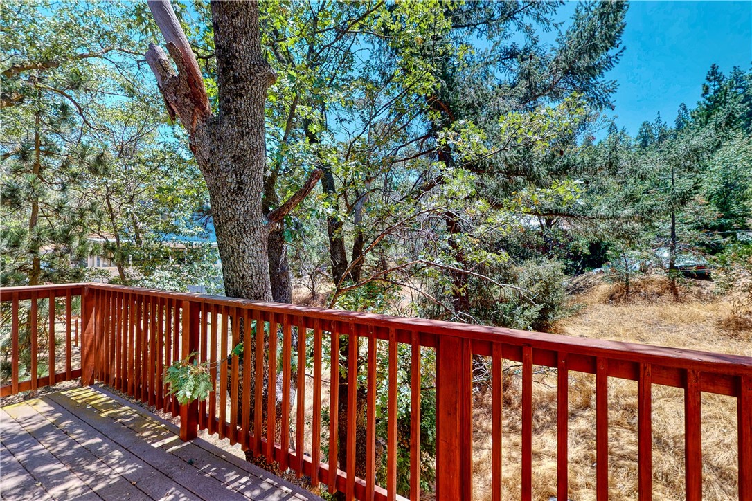 319 Triangle Nook Road Cedarpines Park, CA 92322 - Photo 7 of 8 a balcony with wooden floor and fence