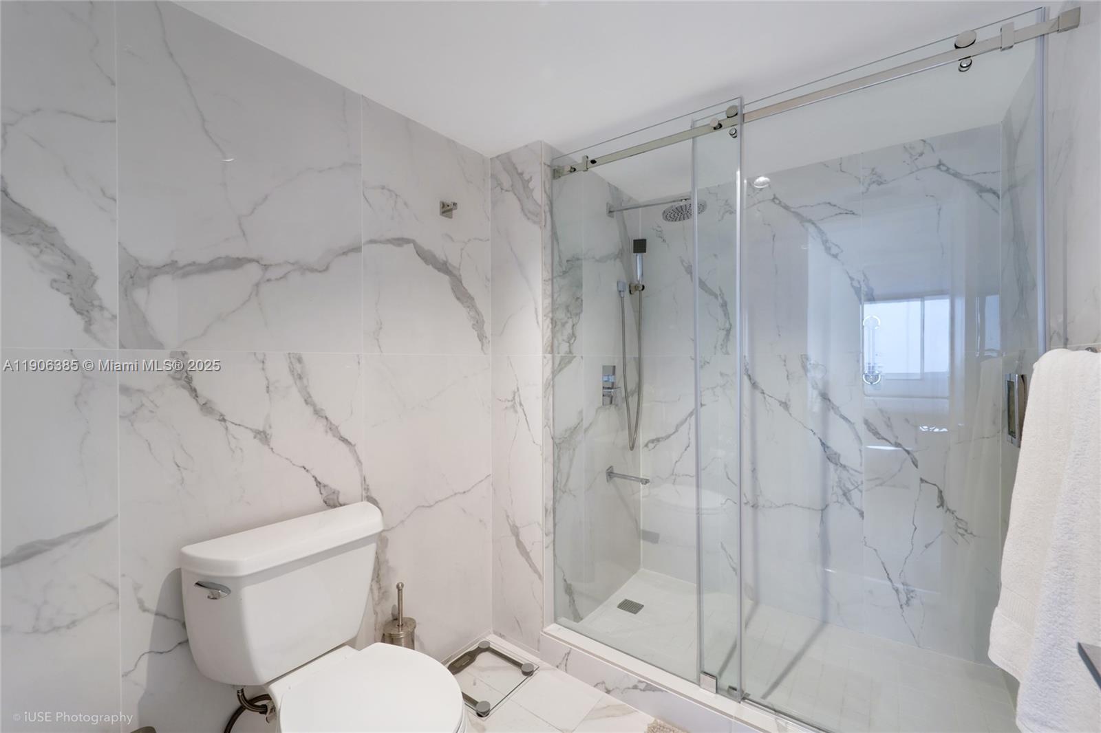881 Ocean Drive, Unit 5D Key Biscayne, FL 33149 - Photo 12 of 18 a bathroom with a shower and toilet
