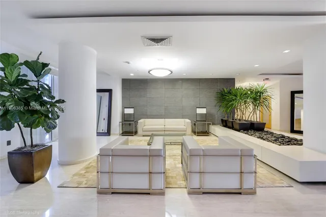 a living room with furniture and a potted plant