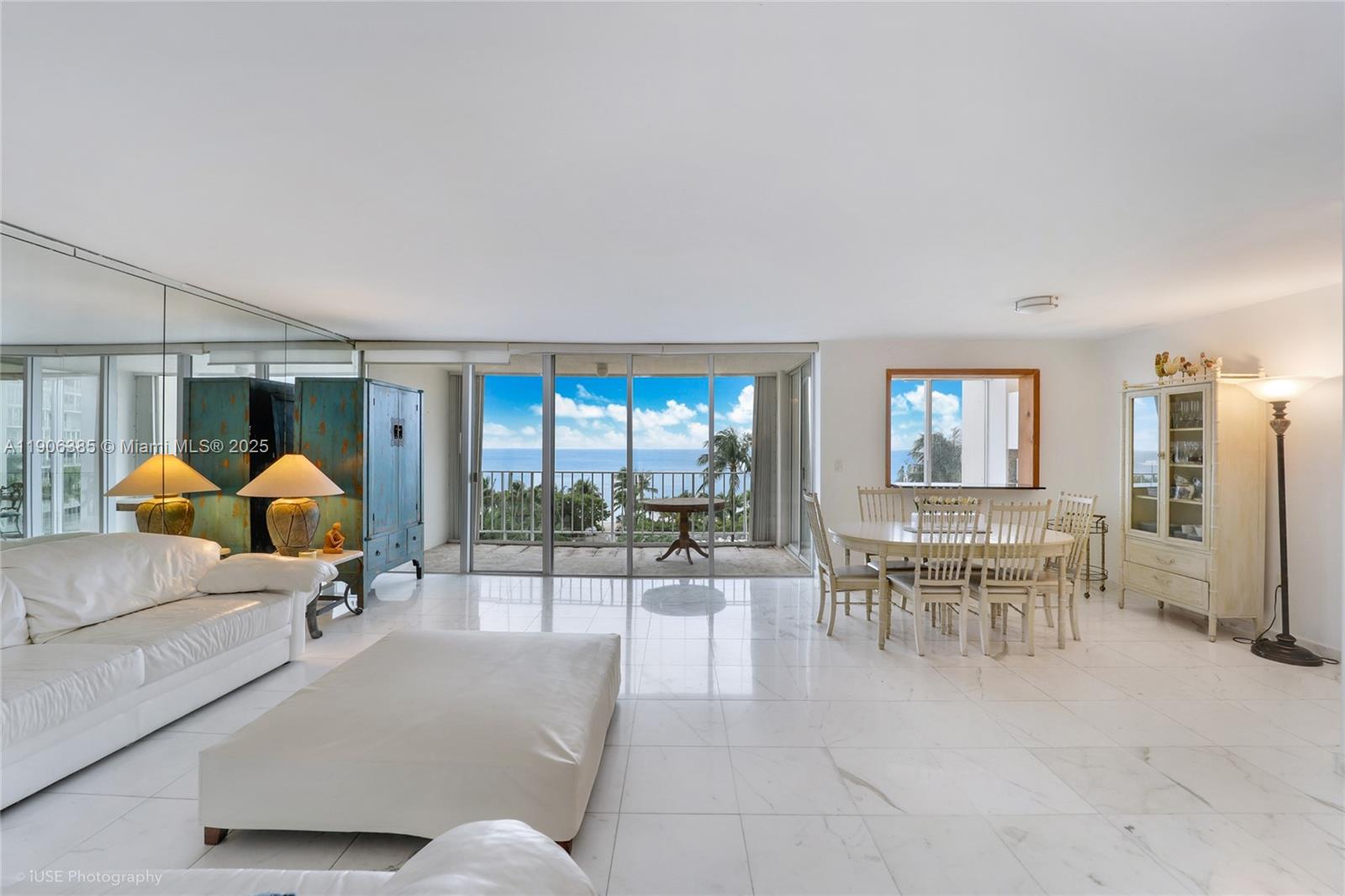 881 Ocean Drive, Unit 5D Key Biscayne, FL 33149 - Photo 3 of 18 a living room with furniture a chandelier and a window