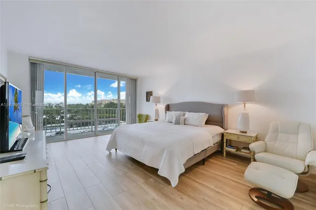 a spacious bedroom with a bed and glass door