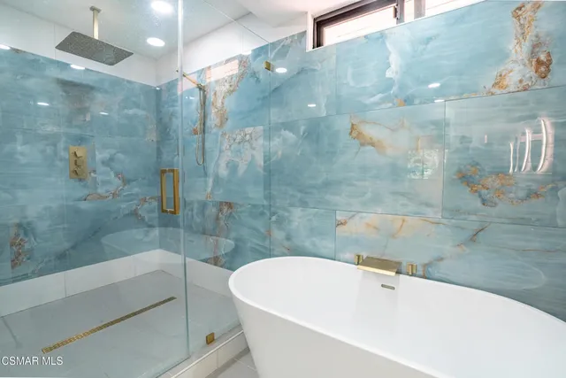 a bathroom with a bathtub and shower