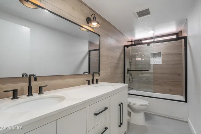 a bathroom with a sink shower and a toilet