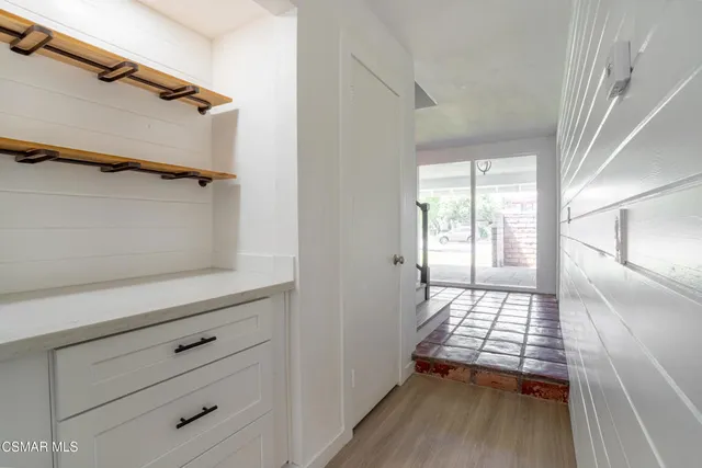 walk in closet with wooden floor