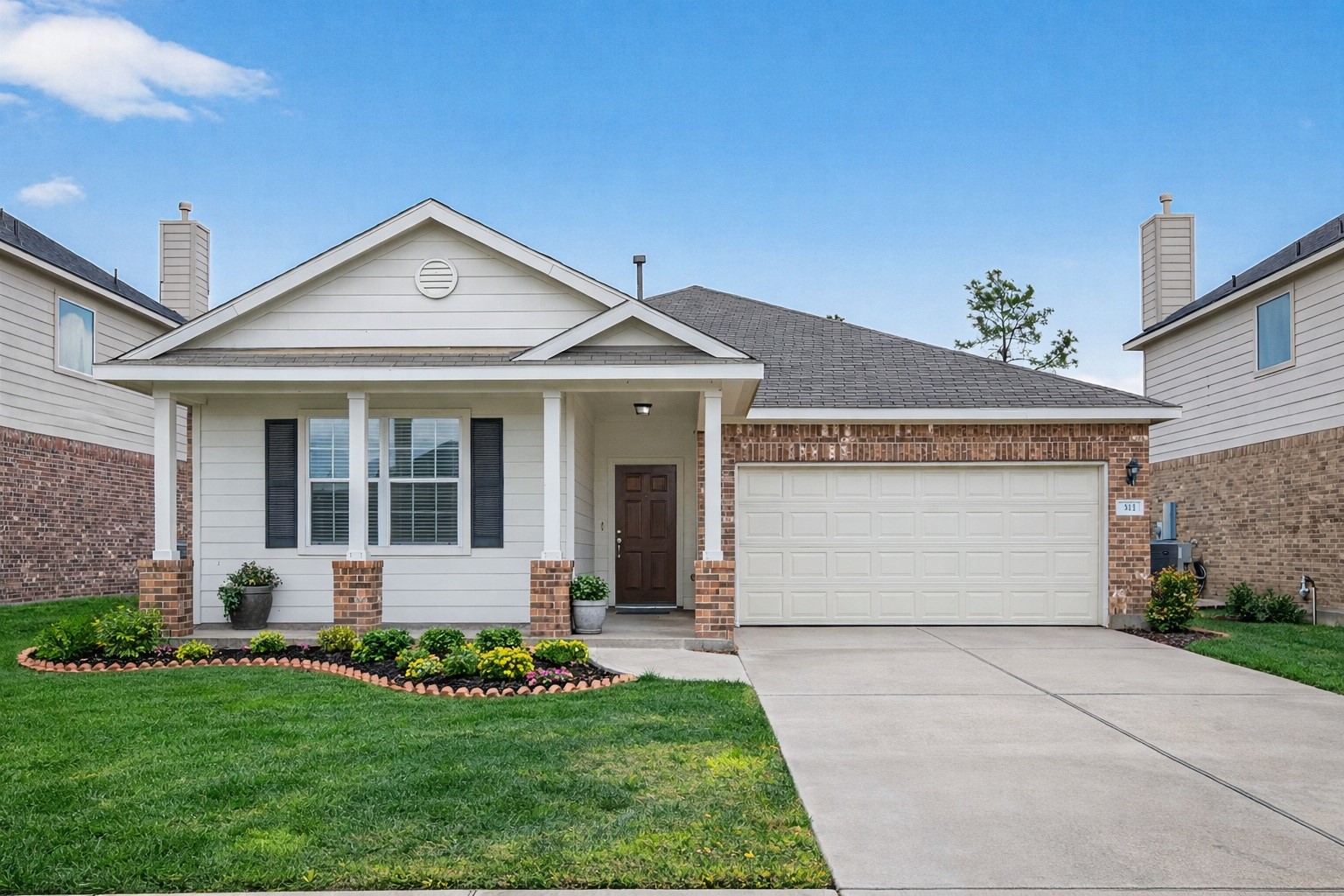 311 Volute Drive Rosharon, TX 77583 - Photo 1 of 17 a front view of a house with a garden and yard