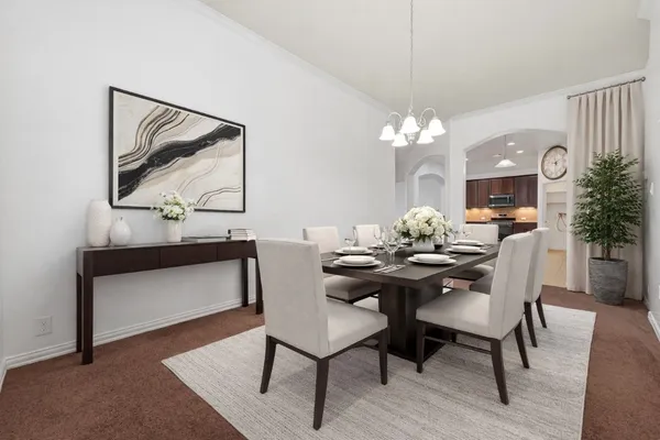 a view of a dining room with furniture and chandelier