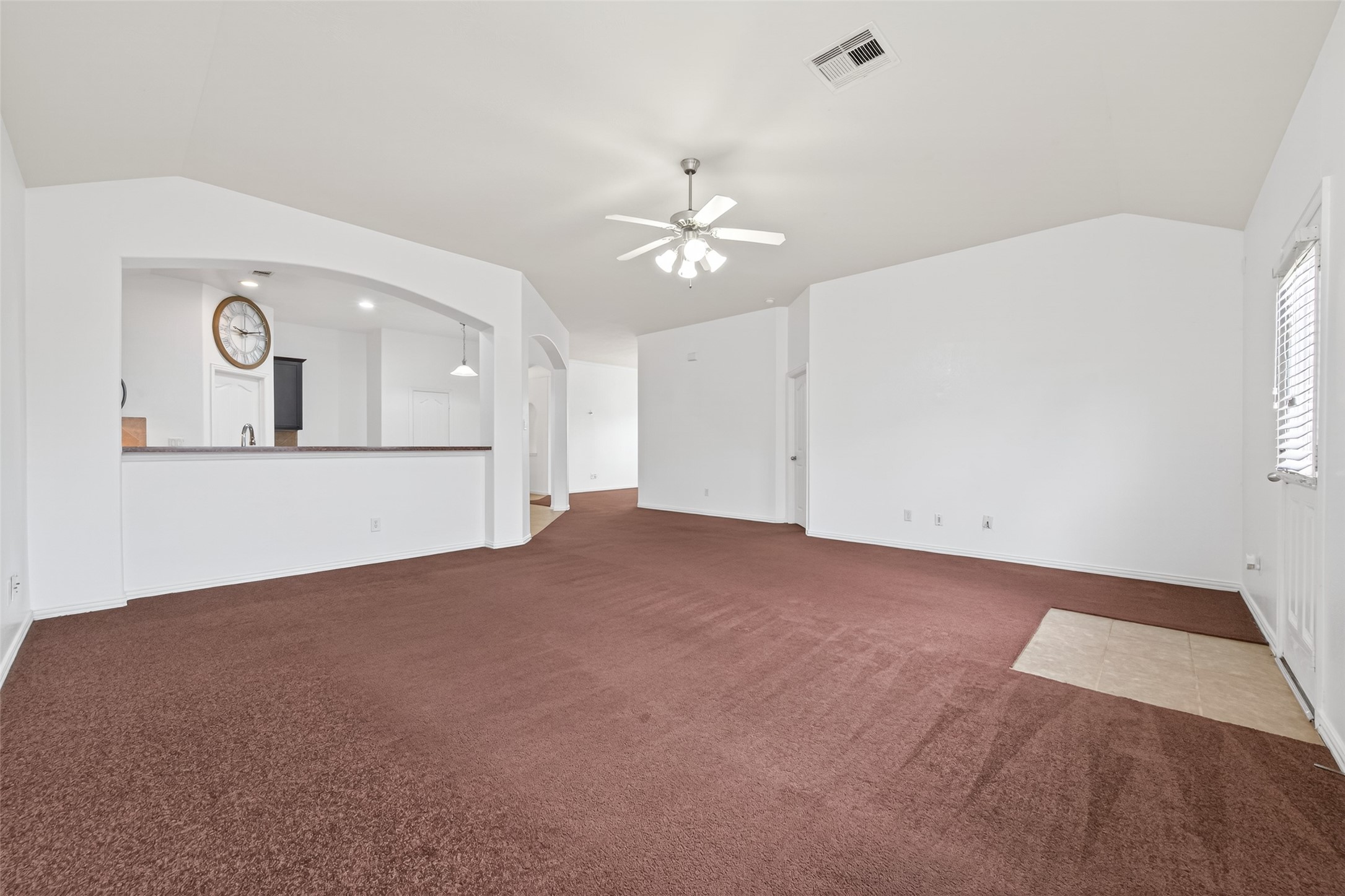 311 Volute Drive Rosharon, TX 77583 - Photo 5 of 21 an empty room with a chandelier fan and windows