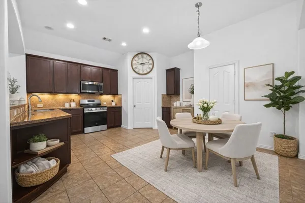 a view of kitchen with sink and dining table