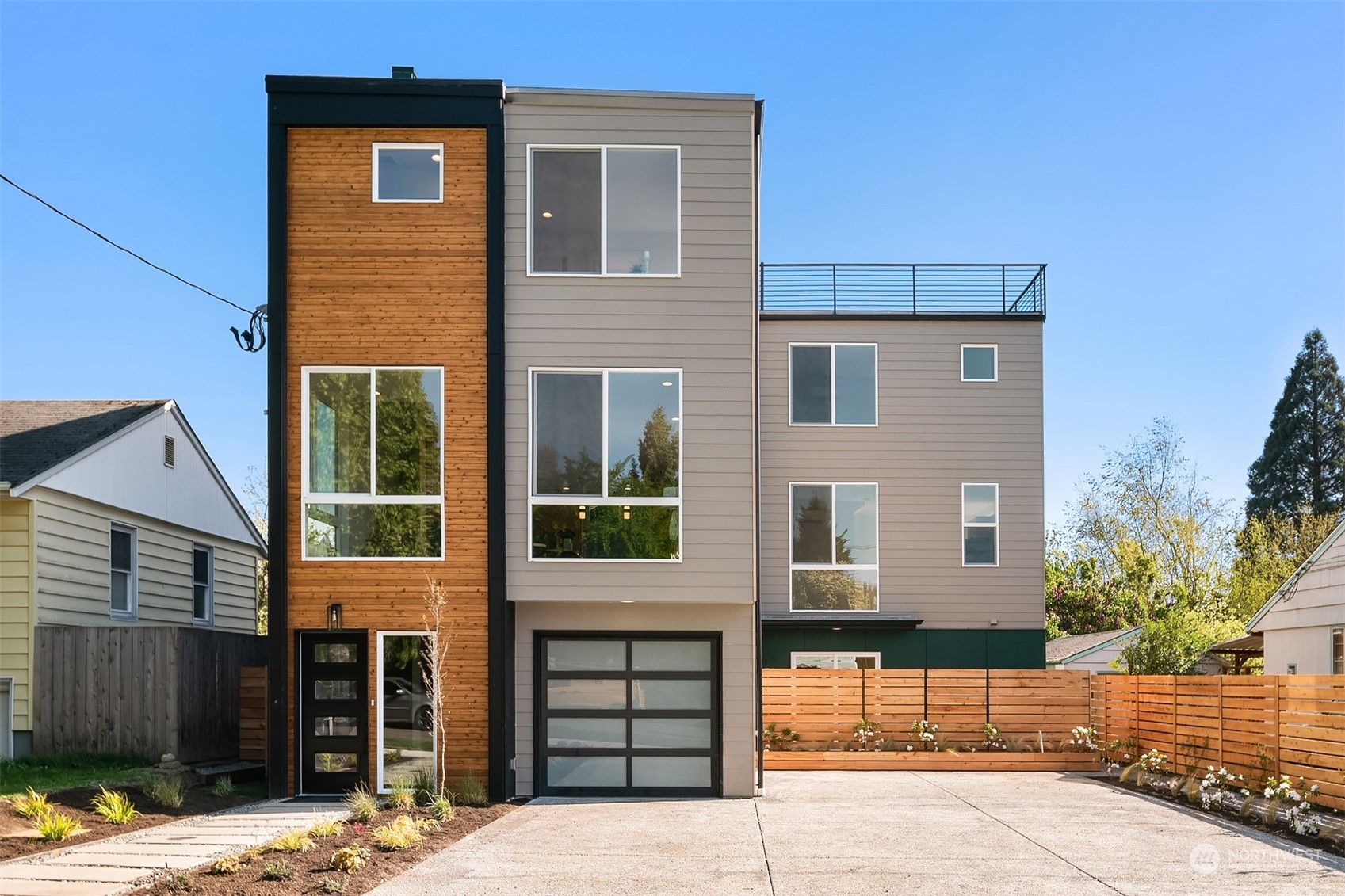 647 Northwest 54th Street, Unit A Seattle, WA 98107 - Photo 1 of 28 a front view of a house with a yard