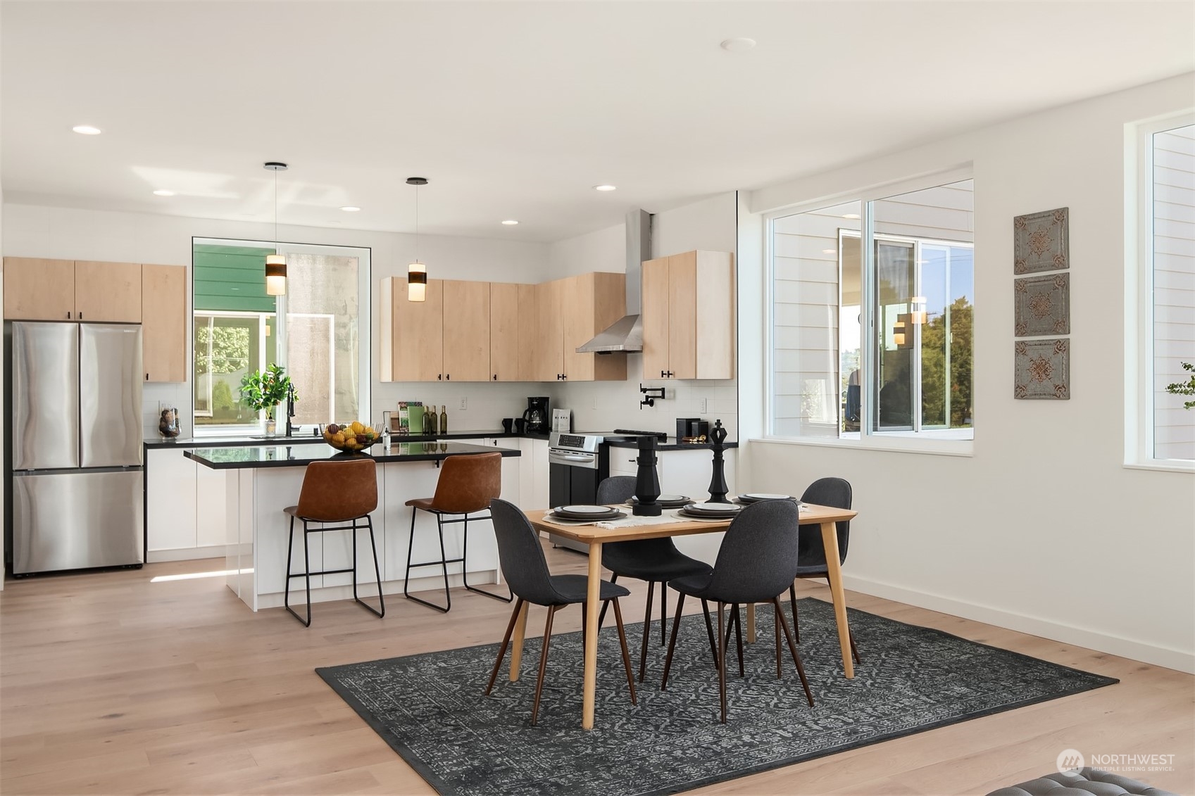 647 Northwest 54th Street, Unit A Seattle, WA 98107 - Photo 11 of 28 a kitchen with a dining table chairs and refrigerator