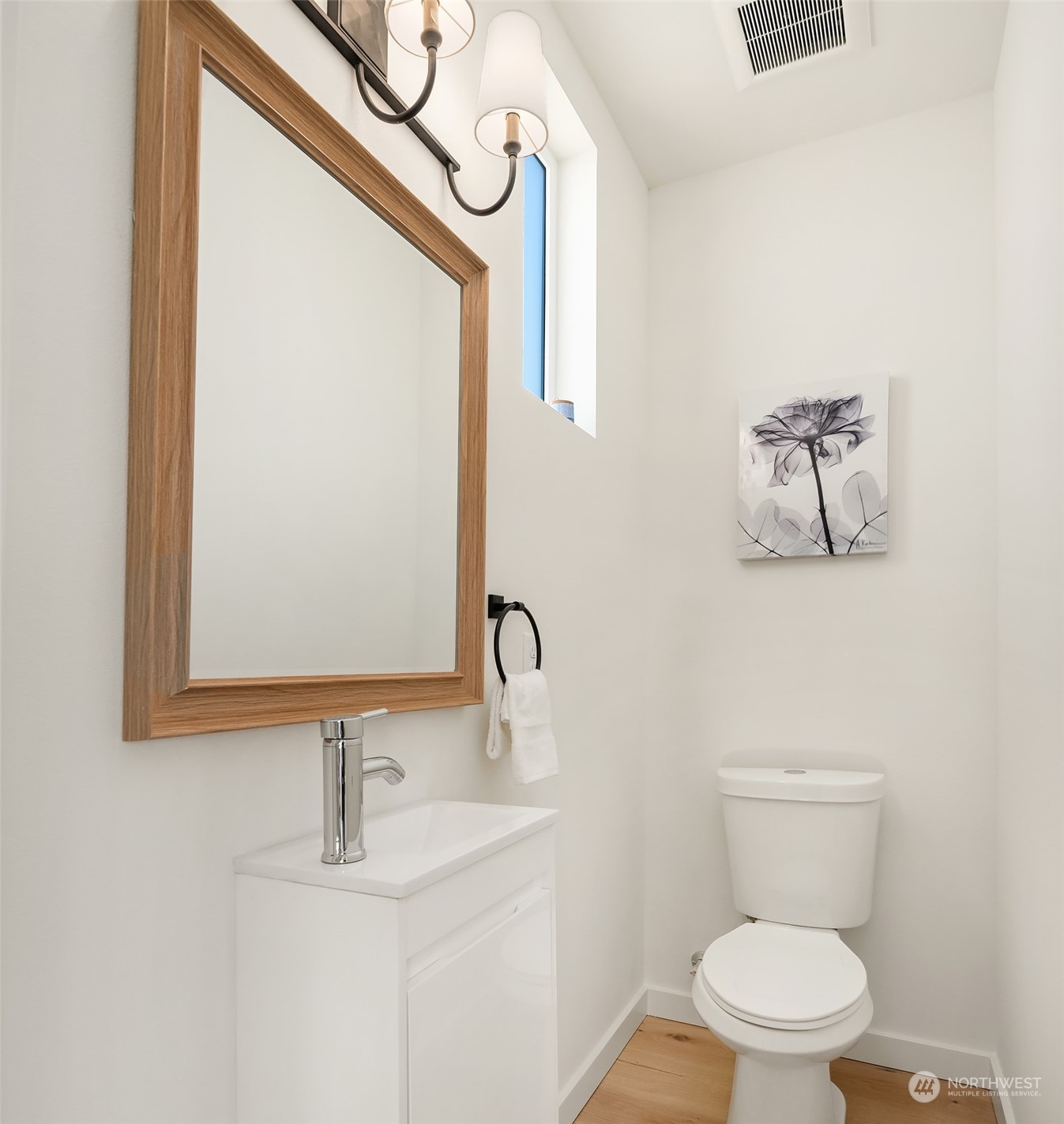 647 Northwest 54th Street, Unit A Seattle, WA 98107 - Photo 18 of 28 a bathroom with a toilet sink and mirror