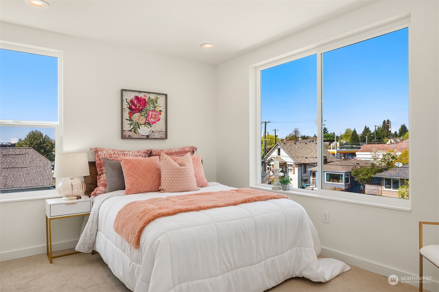 647 Northwest 54th Street, Unit A Seattle, WA 98107 - Photo 19 of 28 a bedroom with a bed and a large window
