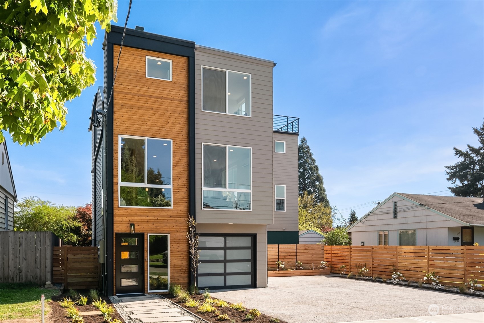 647 Northwest 54th Street, Unit A Seattle, WA 98107 - Photo 2 of 28 a front view of a house with a tree