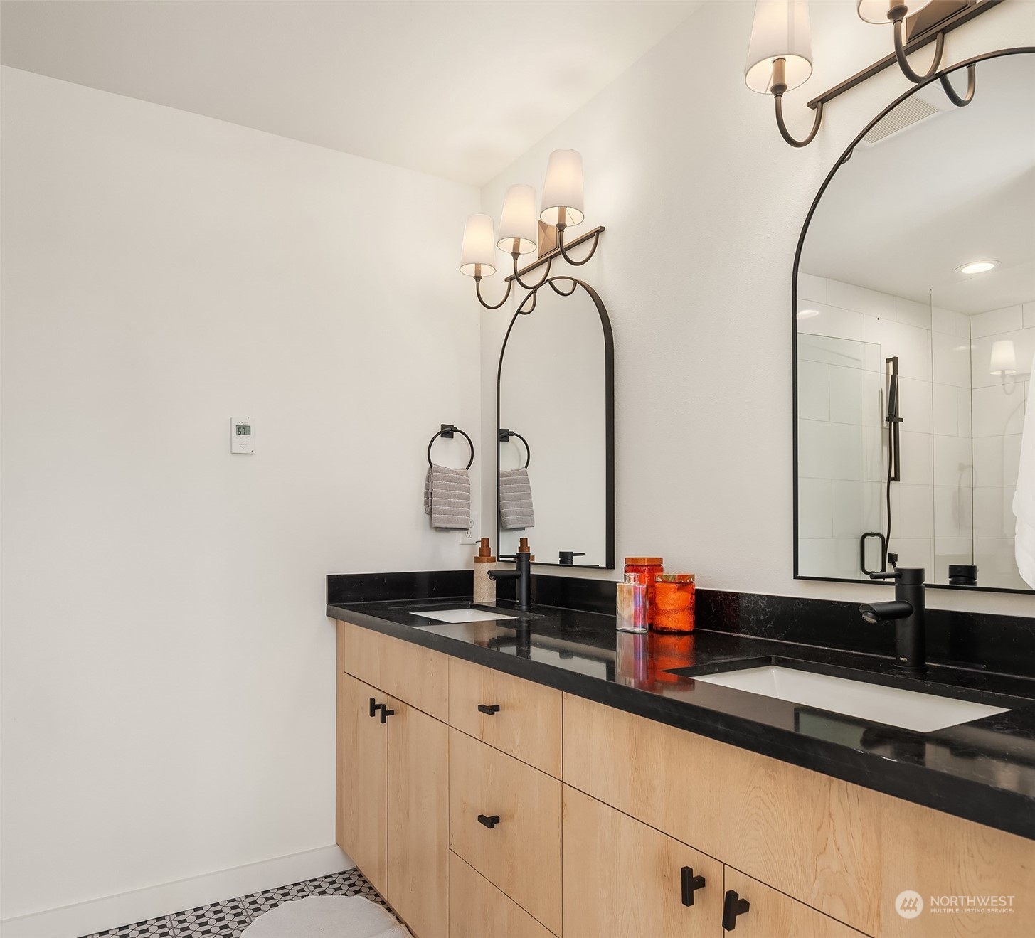 647 Northwest 54th Street, Unit A Seattle, WA 98107 - Photo 23 of 28 a bathroom with a sink and a mirror