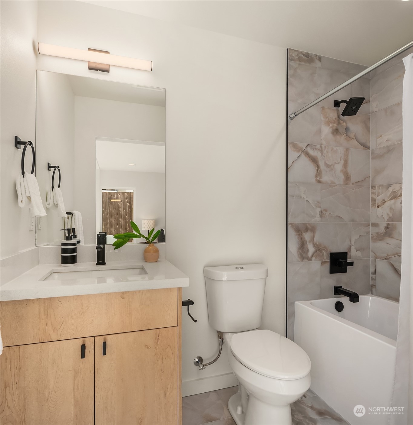 647 Northwest 54th Street, Unit A Seattle, WA 98107 - Photo 6 of 28 a bathroom with a sink a toilet and shower