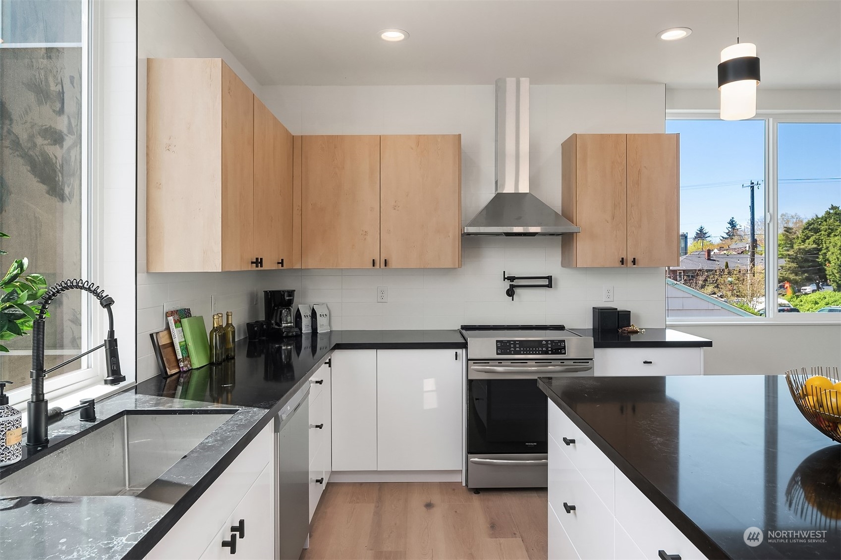 647 Northwest 54th Street, Unit A Seattle, WA 98107 - Photo 7 of 28 a kitchen with stainless steel appliances granite countertop a sink stove and refrigerator