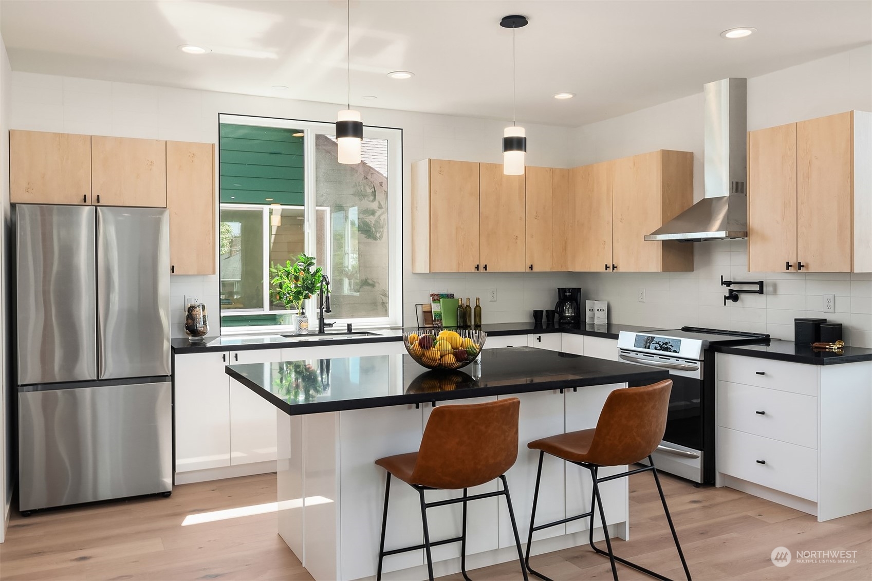 647 Northwest 54th Street, Unit A Seattle, WA 98107 - Photo 8 of 28 a kitchen with stainless steel appliances granite countertop a stove a sink a microwave a refrigerator and white cabinets
