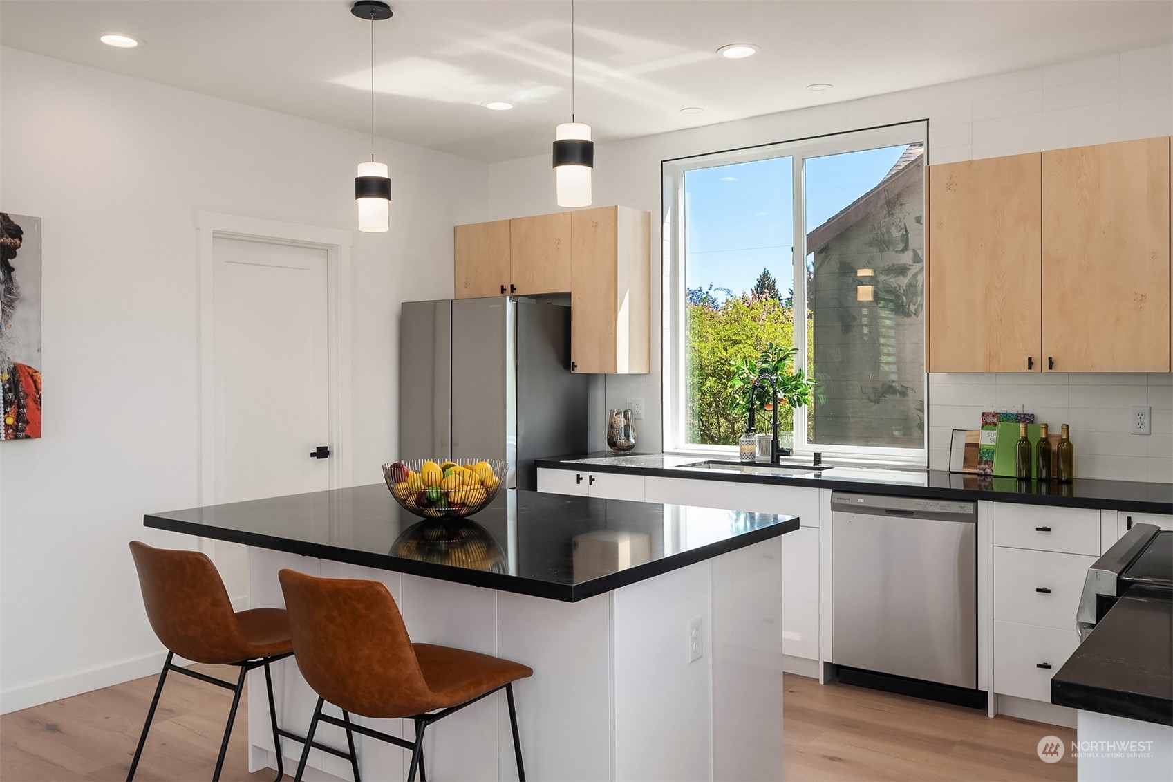 647 Northwest 54th Street, Unit A Seattle, WA 98107 - Photo 9 of 28 a kitchen with stainless steel appliances granite countertop a sink refrigerator and microwave