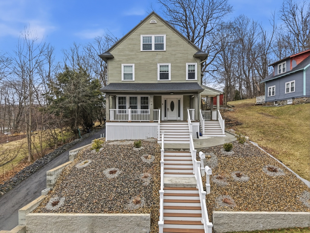 a front view of a house with a yard and trees