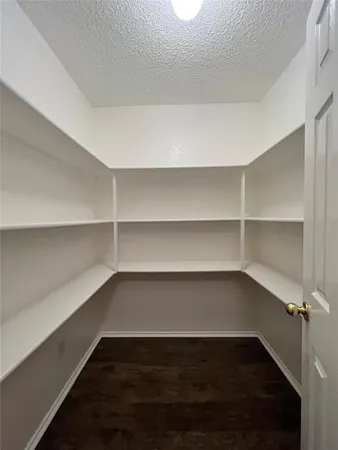a view of a room with a wooden floor and shelf