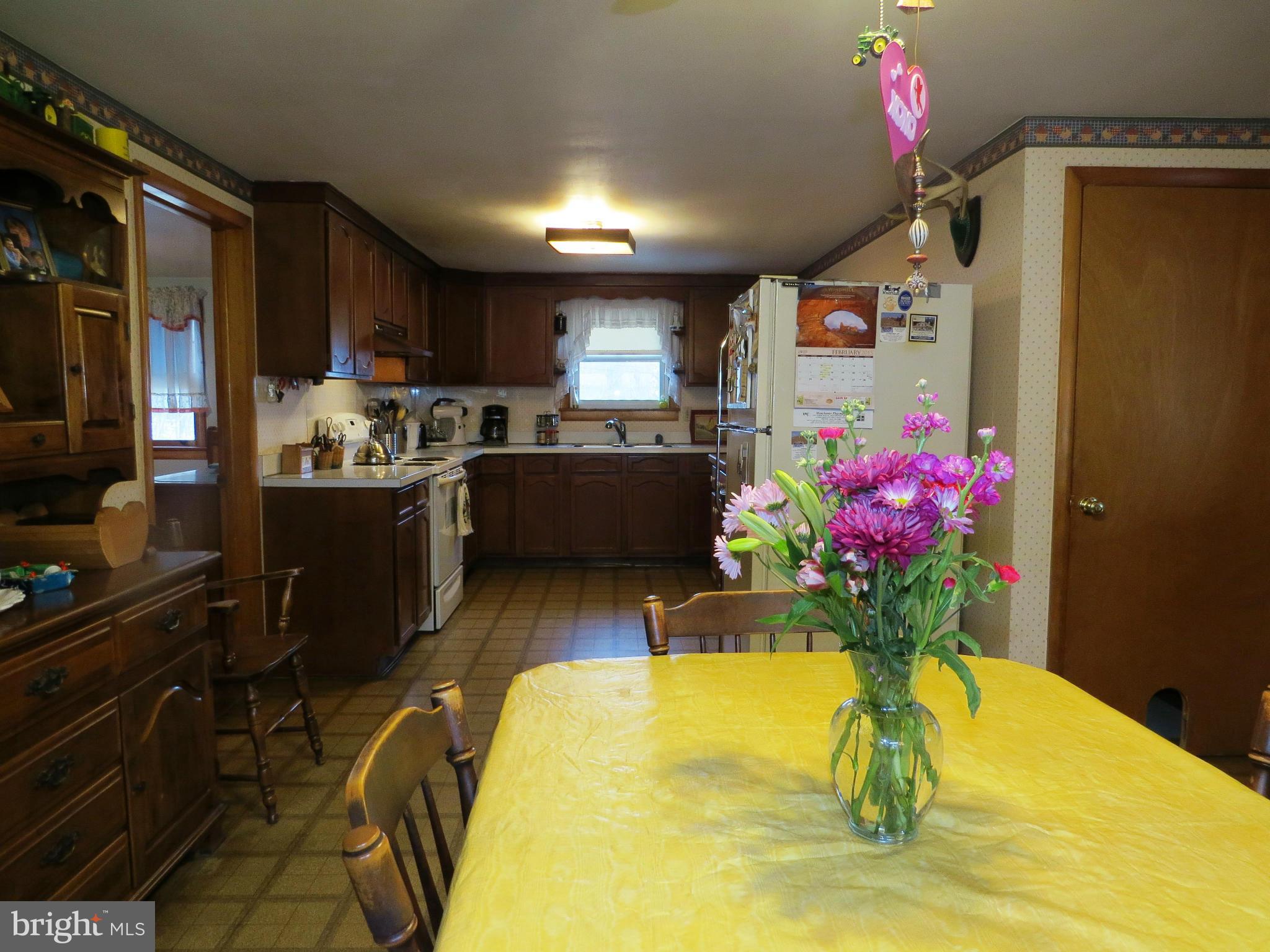 5330 St Pauls Road Manchester, MD 21102 - Photo 2 of 23 a dining room with kitchen island granite countertop furniture and a fireplace