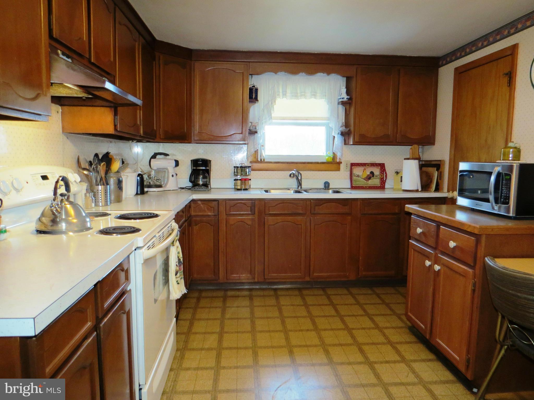5330 St Pauls Road Manchester, MD 21102 - Photo 3 of 23 a kitchen with a sink a stove cabinets and wooden floor