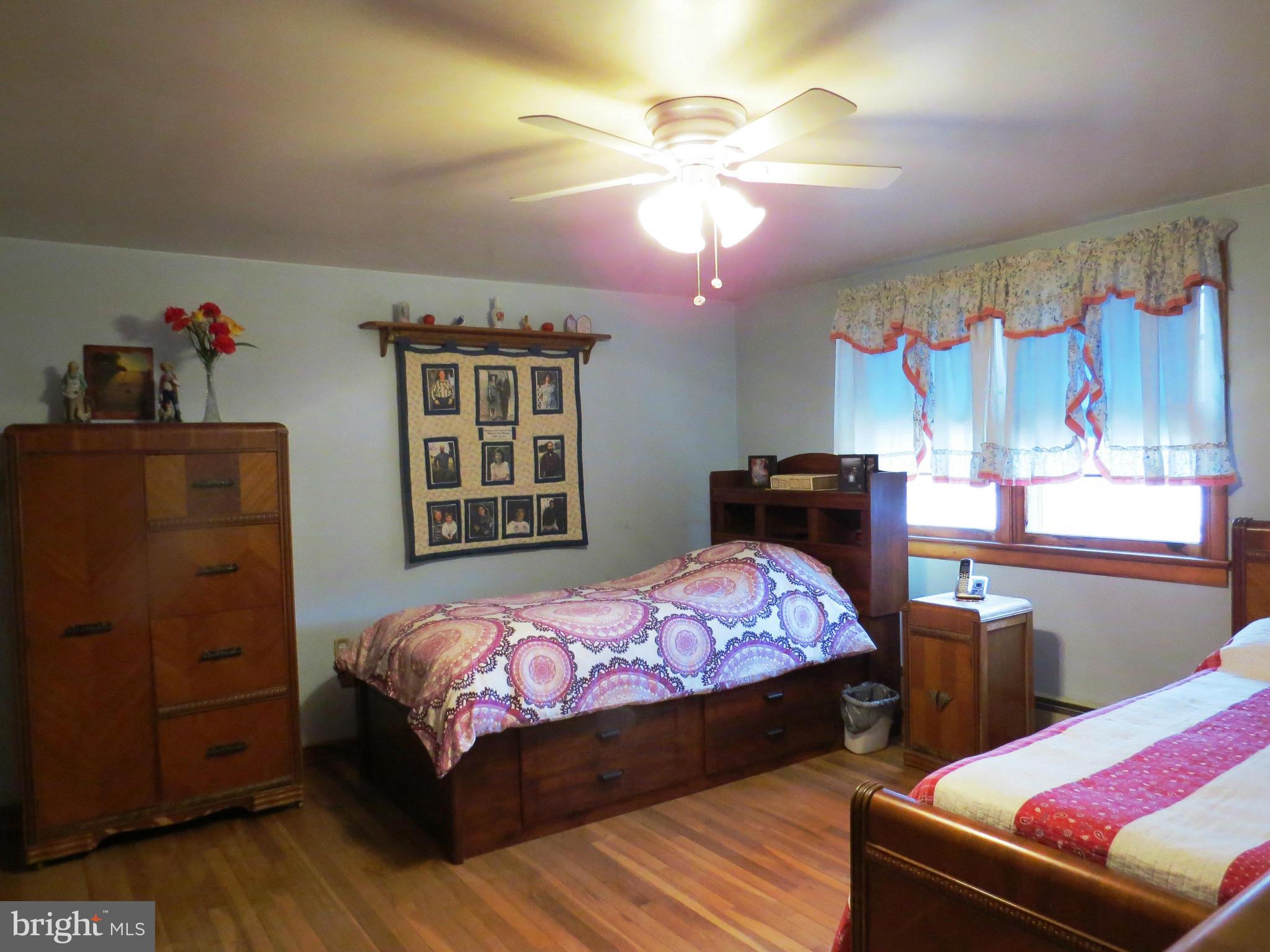 5330 St Pauls Road Manchester, MD 21102 - Photo 8 of 23 a bedroom with two beds and a chandelier