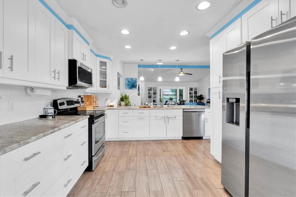 10105 Briar Circle Hudson, FL 34667 - Photo 12 of 40 a kitchen with white cabinets and stainless steel appliances