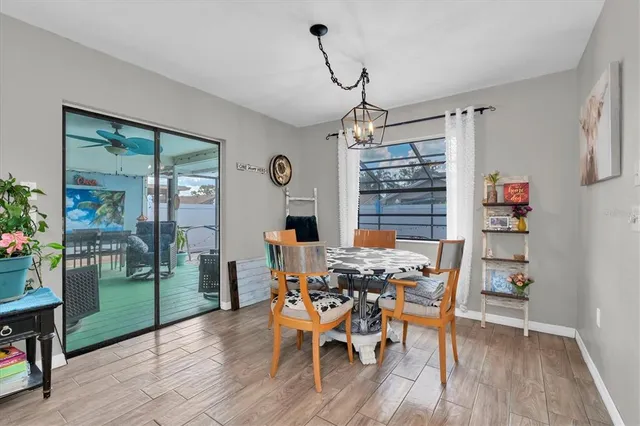 a dining room with furniture and wooden floor