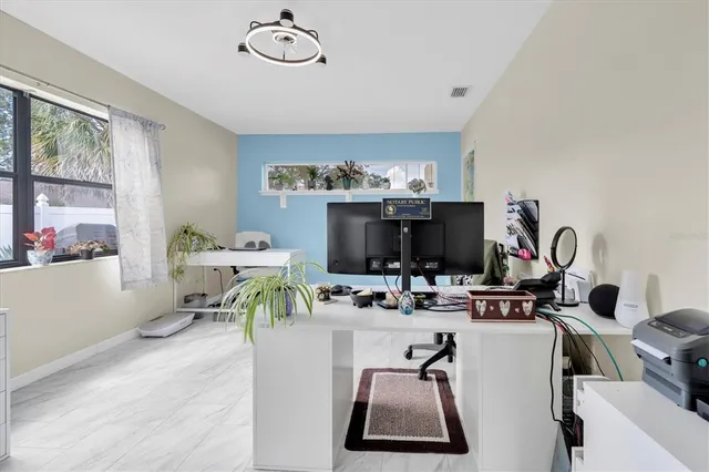 a living room with furniture a flat screen tv and a floor to ceiling window