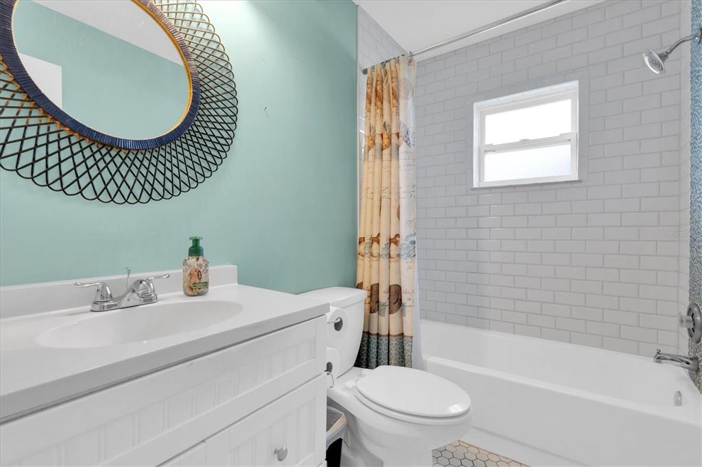 10105 Briar Circle Hudson, FL 34667 - Photo 23 of 40 a bathroom with a sink a mirror a toilet and a bathtub