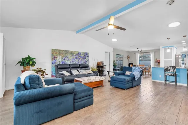 a living room with furniture and a ceiling fan