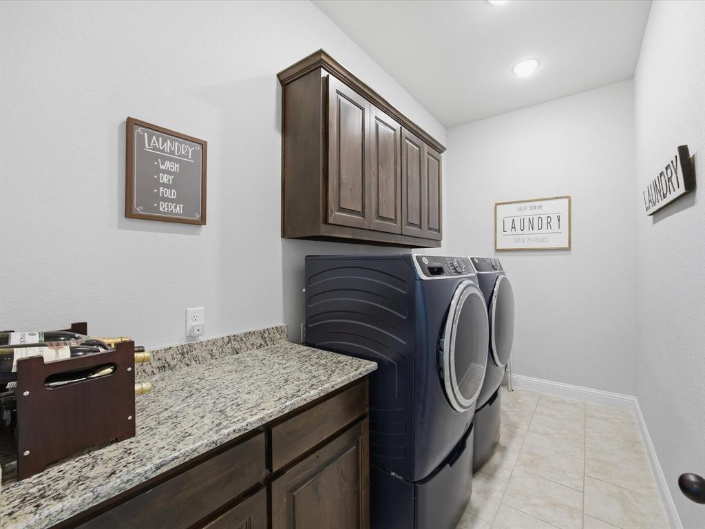 150 Quail Ridge Decatur, TX 76234 - Photo 23 of 32 a utility room with granite countertop washer and dryer