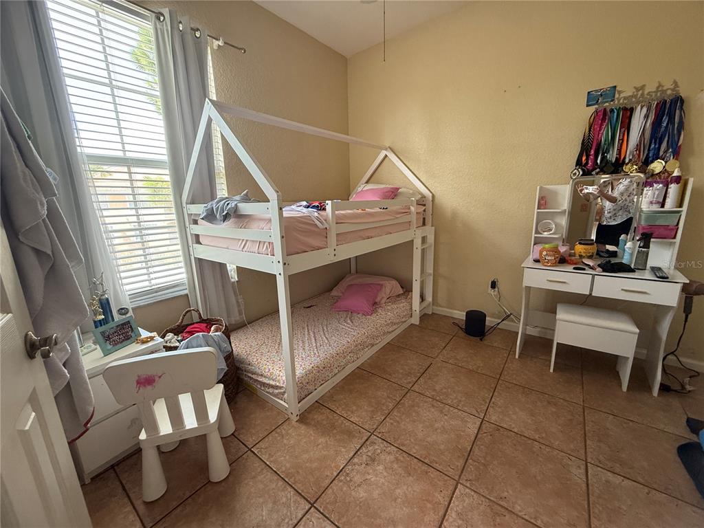 13572 Turtle Marsh Loop, Unit 230 Orlando, FL 32837 - Photo 12 of 14 a bedroom with furniture and a window