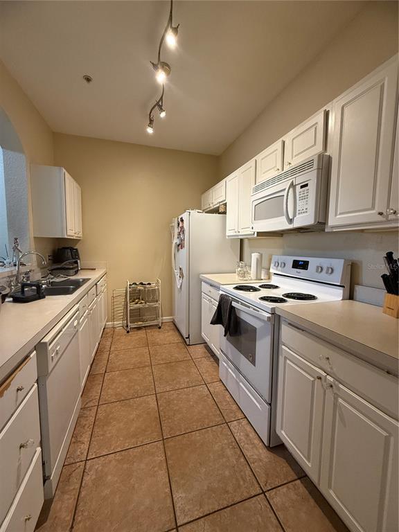 13572 Turtle Marsh Loop, Unit 230 Orlando, FL 32837 - Photo 6 of 14 a kitchen with stainless steel appliances granite countertop a stove a sink and a refrigerator