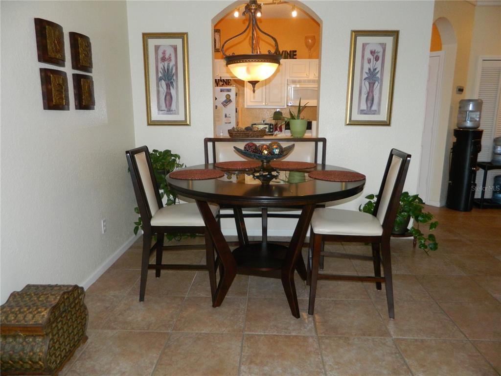 13572 Turtle Marsh Loop, Unit 230 Orlando, FL 32837 - Photo 9 of 14 a view of a dining room with furniture