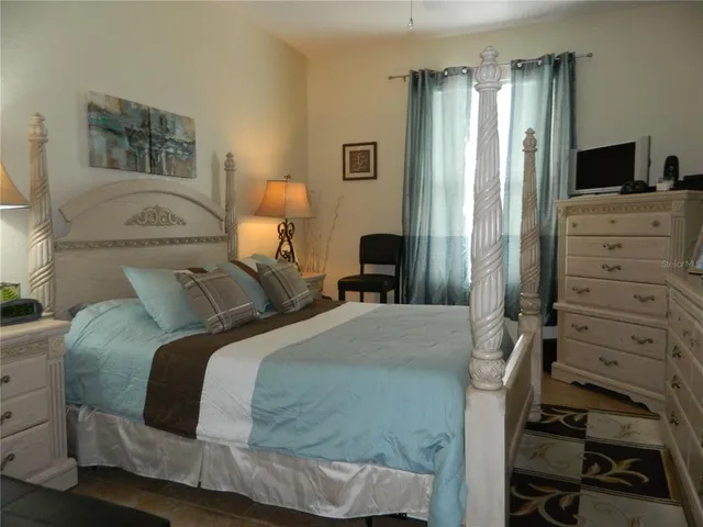 a bed room with a bed and a chair