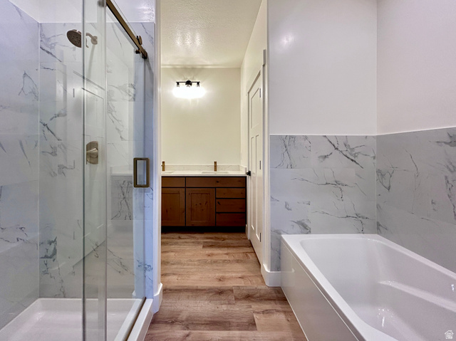 6 South 450th West Gunnison, UT 84634 - Photo 29 of 45 Walk-in shower with a glass sliding door, brushed nickel fixtures, and white marble-look tile