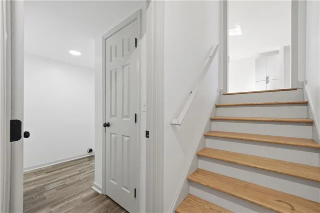 a view of a hallway with wooden floor and entryway
